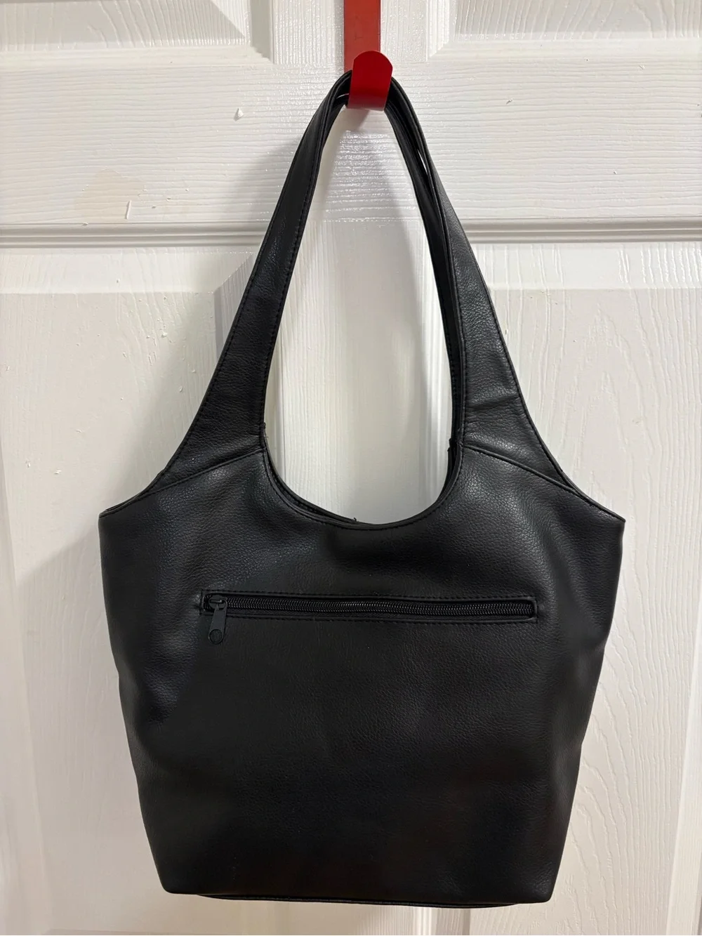 black hobo-style shoulder bag , measures 9 by 14 by 4 inches